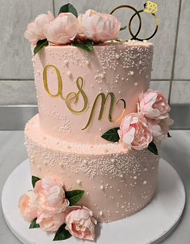 Blush two-tier cake with pearls and peonies
